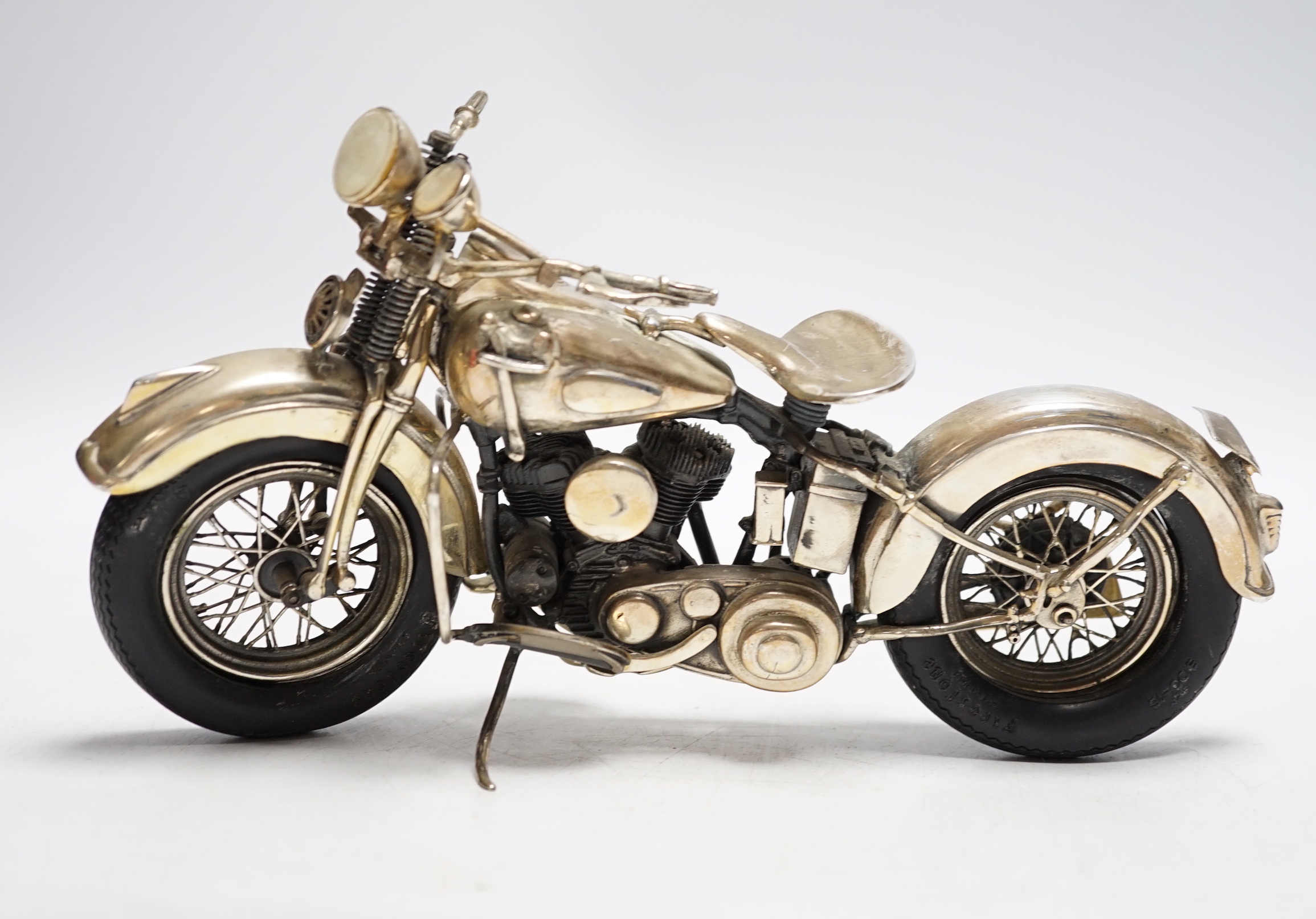 A late 1990's part silver miniature model of a Harley Davidson motor bike, Casa Julia International, London, 1997, length 23.3cm, gross weight 24.9oz.